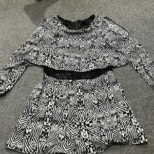 Trendy black and white print romper with lace in the mid drift area